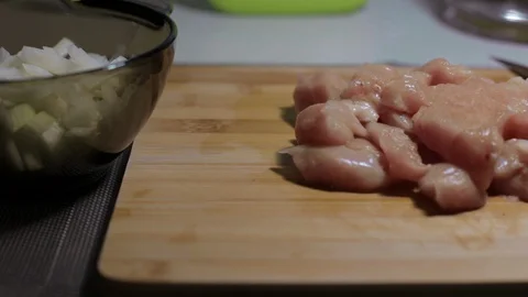 Raw chicken meat on a cutting board, cooking at home Stock Footage 128387771