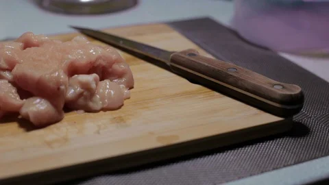 Raw chicken meat on a cutting board, cooking at home Stock Footage 128387786