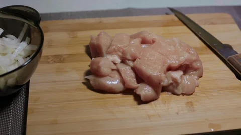 Raw chicken meat on a cutting board, cooking at home Stock Footage 128387800