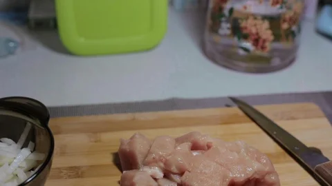 Raw chicken meat on a cutting board, cooking at home Stock Footage 128387804