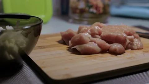 Raw chicken meat on a cutting board, cooking at home Stock Footage 128387857