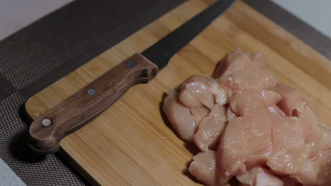 Raw chicken meat on a cutting board, cooking at home Stock Footage 128448378