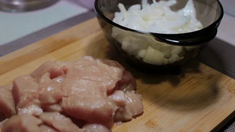 Raw chicken meat on a cutting board, cooking at home Stock Footage 128448414