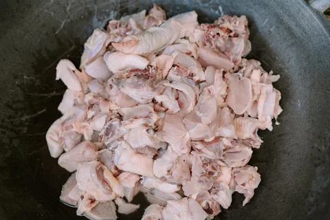 Raw chicken meat placed inside a large metal wok, Stock Photos