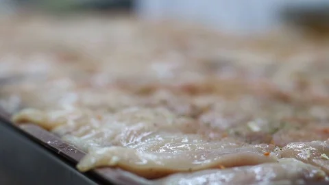 Raw chicken ready for marinade with lemon. Professional chef in a kitchen of res Stock Footage 90665693