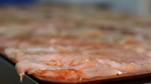 Raw chicken ready for marinade with lemon. Professional chef in a kitchen of res Stock Footage 90665706