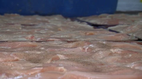 Raw chicken ready for marinade with lemon and pepper. Professional chef in  Stock Footage 90666412