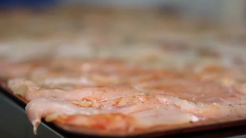 Raw chicken ready for marinade with lemon and pepper. Professional chef in  Stock Footage 90666719