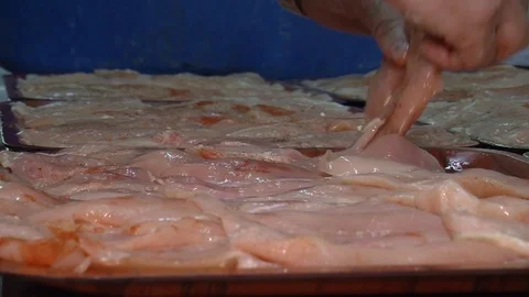 Raw chicken ready for marinade with lemon and pepper. Professional chef in  Stock Footage 90667162