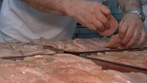 Raw chicken ready for marinade with lemon and pepper. Professional chef in  Stock Footage 90667767