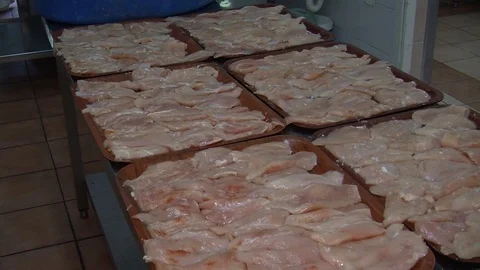 Raw chicken ready for marinade with lemon and pepper. Professional chef in  Stock Footage 90667841