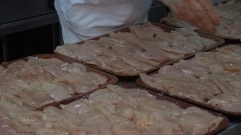 Raw chicken ready for marinade with lemon and pepper. Professional chef in  Stock Footage 90668211