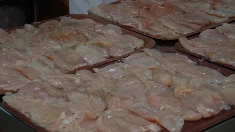 Raw chicken ready for marinade with lemon and pepper. Professional chef in  Stock Footage 90668469