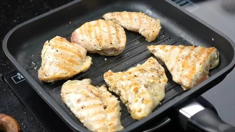 Raw Chicken roasting in pan Stock Photos