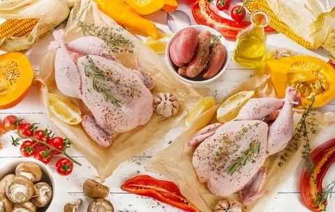 Raw chicken with vegetables Stock Photos