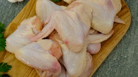 Raw chicken wings on a board. selective focus. Stock Footage 197564150