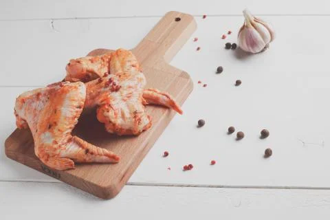 Raw chicken wings on cutting board Stock Photos
