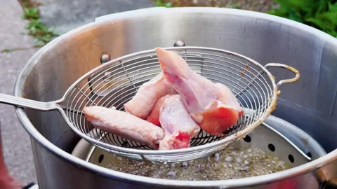 Raw Chicken Wings Dropped Into Bubbling Hot Oil Stock Footage 346649116
