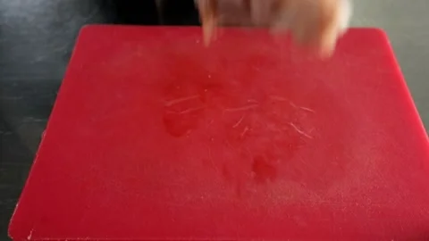 Raw chicken wings fall onto a meat cutting board. Stock Footage 159155771