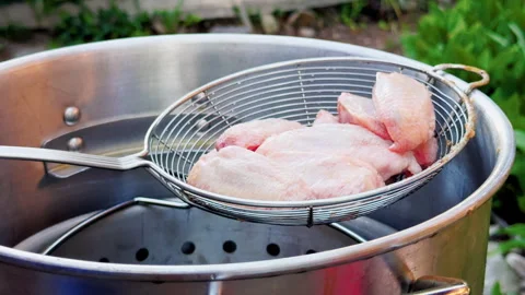 Raw Chicken Wings Loaded Into Outdoor Deep Fryer Stock Footage 346649121