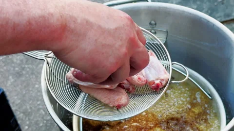Raw Chicken Wings Lowered Into Bubbling Hot Oil Stock Footage 346648841