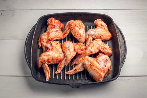 Raw chicken wings marinated Stock Photos
