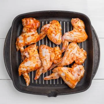 Raw chicken wings marinated Stock Photos
