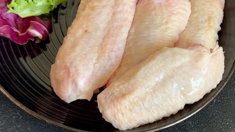 Raw chicken wings poultry meat main course lunch or dinner tasty Stock Footage 333926052