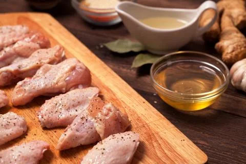 Raw chicken wings on a wooden table. Stock Photos