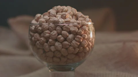 Raw chickpeas in a container Stockbeeldmateriaal 131454131