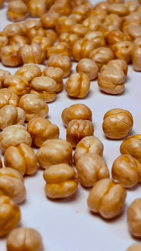 Raw chickpeas on white background, vertical format, close up angled view Stock Footage 336471552