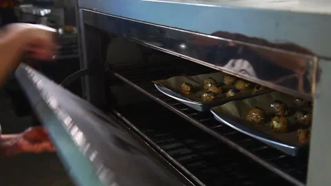Raw Chocolate Chip Cookies Being Placed in the Oven Stock Footage 332405703
