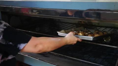 Raw Chocolate Chip Cookies Being Placed in the Oven Stock Footage 332405718