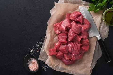 Raw chopped beef meat. Raw organic meat beef or lamb, spices, herbs on old pa Stock Photos