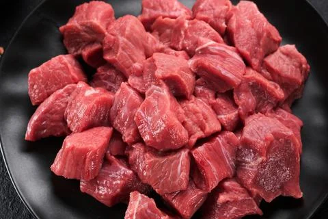 Raw chopped beef meat. Raw organic meat beef or lamb, spices, herbs on black  Stock Photos