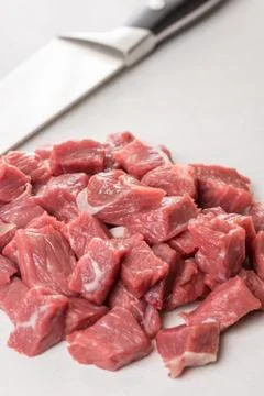 Raw chopped beef steak with chef knife in the background Stock Photos