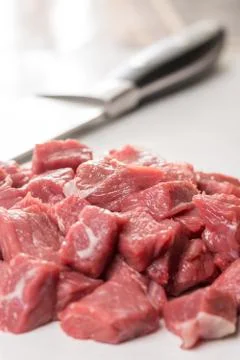 Raw chopped beef steak with chef knife in the background Stock Photos