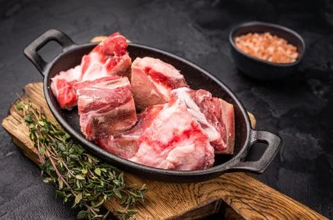 Raw chopped  lamb meat with bones, uncooked mutton ready for cooking. black.. Stock Photos