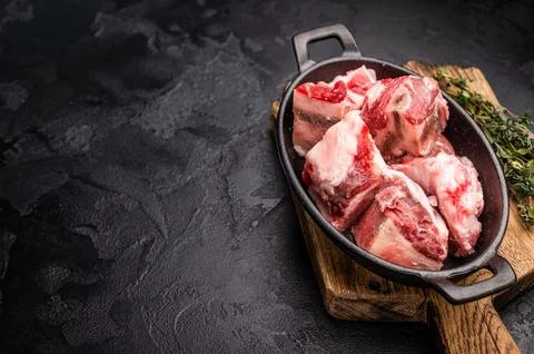 Raw chopped  lamb meat with bones, uncooked mutton ready for cooking. black.. Stock Photos