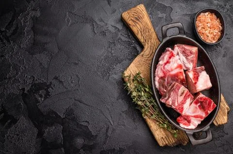 Raw chopped  lamb meat with bones, uncooked mutton ready for cooking. black.. Stock Photos