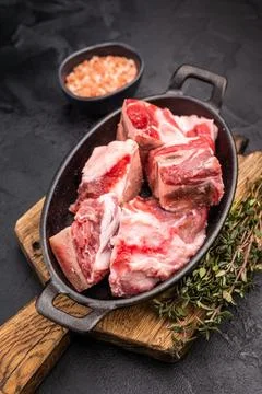 Raw chopped  lamb meat with bones, uncooked mutton ready for cooking. black.. Stock Photos