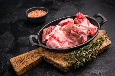 Raw chopped  lamb meat with bones, uncooked mutton ready for cooking. black.. Stock Photos