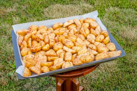 Raw chopped potatoes on a baking sheet. Stock Photos