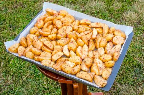 Raw chopped potatoes on a baking sheet. Stock Photos