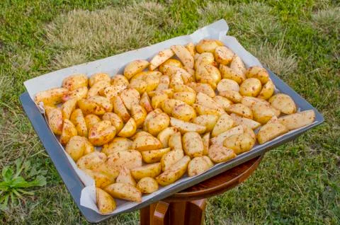 Raw chopped potatoes on a baking sheet. Stock Photos