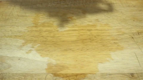 Raw chopped potatoes fall in slow motion on a wooden Stock Footage 129568550