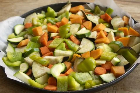 Raw chopped vegetables on baking tray Stock Photos