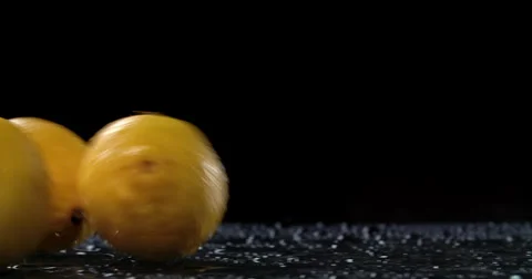 Raw citrus fruit rolling in dark background Stock Footage 58303367