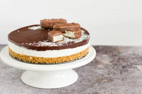 Raw coconut chocolate cake on a cake stand Stock Photos