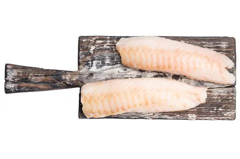 Raw cod Loin, white fish fillets without skin on wooden board isolated on w.. Stock Photos